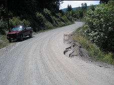 Collapsed culvert cause sinkhole in road shoulder and slipout